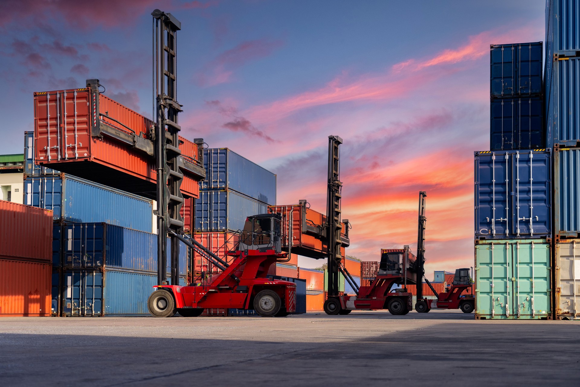 Engineers are overseeing the transportation of cargo with containers inside the warehouse. Container in export and import business and logistics.